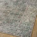 Close angled view of Jules Emerald rug edge laying flat with visible delicate floral borders and texture