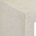 Close-up texture showing tiny irregular beige and brown flecks in ivory terrazzo concrete tabletop
