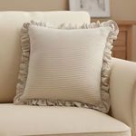 Betty Cushion styled on a cream sofa in warm living room, adding a soft, romantic accent