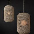 Two hanging pendants in natural lighting with visible warm glow against dark background