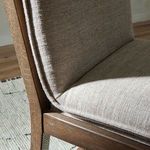 Close-up of leather strap details on the back of Wilmington Stool with almond wood frame and natural lighting