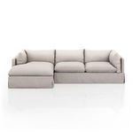Front view with subtle lighting highlighting plush, pillow-inspired seat and back cushions