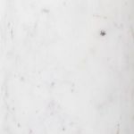 Close-up detail of polished white marble base with subtle gray veining