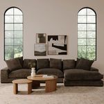 Styled living room scene with oak coffee table and smaller side table in front of dark fabric sofa
