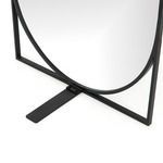 Close-up on matte black rectangular metal base piece supporting the mirror frame