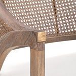 Edward Lounge Chair with white cushion, hand-woven rattan back, and Cape Lilac Mahogany frame with brass accents