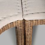 Close-up fabric cushion showing button tuft on smooth neutral upholstery