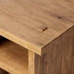 Close-up of one square wood plug and natural wood grain detail on the table top