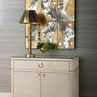 Andre 2-door cabinet staged in room setting with gold lamp and abstract wall art above