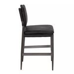 Side profile of ebony black leather stool illustrating seat thickness and steel frame detail