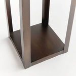 Close-up of bronze lantern base showing smooth metal platform inside the frame