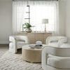 Cascade chairs styled in living room with low round coffee table and sheer window curtains