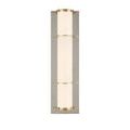 Polished nickel backplate reflecting light with brass ring embellishments on milky glass tube