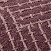 Close-up of raised embroidery texture and intricate pattern on mauve woven fabric