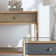 Styled bedside table in room setting with coral decor and lamp nearby, showing use context