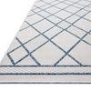 Close-up angled view of Easton Ivory Denim Rug showing texture and edge detail of the ivory and blue diamond design