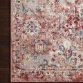 Close-up corner of rug on dark wood floor highlighting old-world floral and geometric details