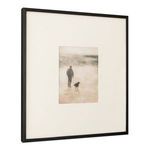 Framed print viewed from angled side displaying black wood frame depth and texture of matte border