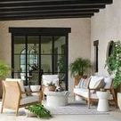 Three-quarter side view of lounge chair with woven raffia back and taupe mesh seat