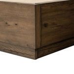 Close-up of rustic wood footboard showing grain pattern and mitered edge construction