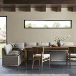 Dining room setting with bench paired with matching banquette and wooden table under beam ceiling