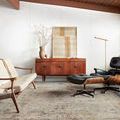 Axel Silver/Spice rug styled in mid-century modern living room with wood furniture and black lounge chair