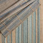 top view of folded rug corner revealing subtle color difference on reverse side
