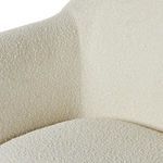 Fabric close-up blending two shades of cream boucle on armrest and seat