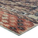 Close-up of rug corner showing detailed terracotta and black geometric border with stitched edges