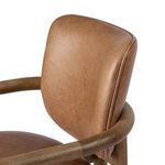 Close-up showing rounded armrest corner and smooth leather upholstery on seat