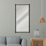 Vintage Elegance Mirror hanging on light gray wall above sofa next to modern wooden side table and pendant light