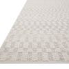 Low-angle view showing rug's thin profile and subtle checkerboard texture