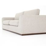 Low angled side view of Colt Sofa showing flared armrest and cushion depth