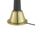 Unlit power switch with black cord attached to brass lamp base
