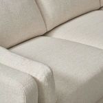 Close-up on the seat and arm cushions highlighting the cream basketweave fabric texture