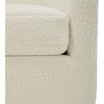 Detailed close-up view of cushioned seat corner with soft boucle fabric on Oscy chair