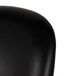 Close-up of upper curved backrest area with smooth black leather