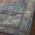 Close-up of the intricate blue and red border floral details against a dark wood floor