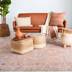 Marquesa rug styled with additional boho elements like terracotta pottery and wooden beads on tray.