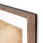 Close-up of walnut frame corner showing fine wood grain and white mat border
