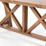 Detailed view of X-shaped cross beams and base wood grain under the Trellis table top
