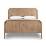 Front view of the bed showing full curved contours of headboard and footboard with two pillows