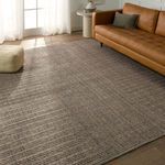 rug styled in a living room with caramel leather sofa and natural light highlighting texture