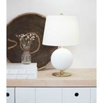 Grant Mini Lamp styled on wooden surface with decorative vase, books, and woven wall art backdrop