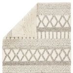 Rug with one corner folded, showing wool weave on front and back sides