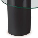 Close detail of black cylinder base surface beneath clear glass top