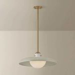 Pendant light hanging with illuminated opal glass orb under off white shade and brass rod ceiling mount