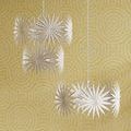 Two Bismarkia chandeliers hanging next to each other against yellow textured wall background