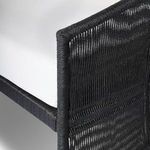 Close-up of vertical rope strands wrapping around the edge frame of sofa arm