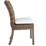 Side angle showing cushion thickness and rattan weave under seat from opposite profile